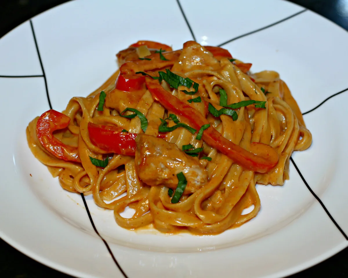 A plate of fettuccine pasta in a creamy sauce